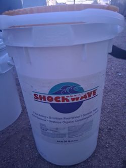 50-pound bucket of Shockwave Granular Pool Shock, which is a powerful chemical treatment used to clean and maintain swimming pools.