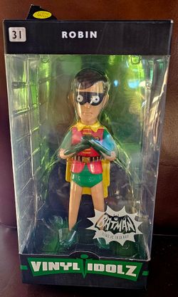 Funko Vinyl Idolz #31 figure of Robin from the 1966 Batman Classic TV Series.The figure stands approximately 8 inches tall and features stylized vinyl