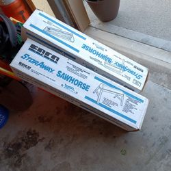 TWO  FOLDING METAL SAWHORSES