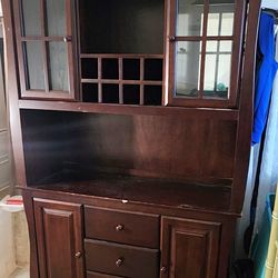 Dark wood hutch cabinet. A wine rack and a lower buffer section with drawers and enclosed  storage