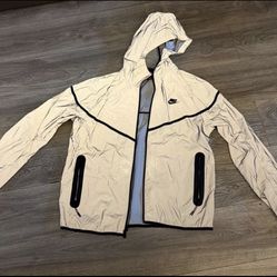 Nike Sportswear Tech Woven Windrunner Full-Zip Hooded Jacket in a reflective silver/grey colorway. 