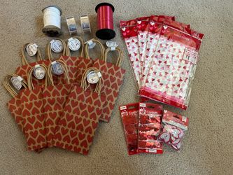 9 packages of gift bags, 27 bags, 4 tablecloths, 4 Ribbons, 2 packages of Confetti, Package of Heart Fabric Stickers