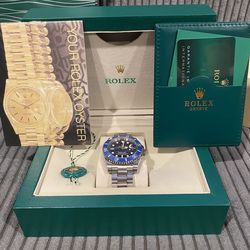 Blue watch with logos, box, bag, and tools