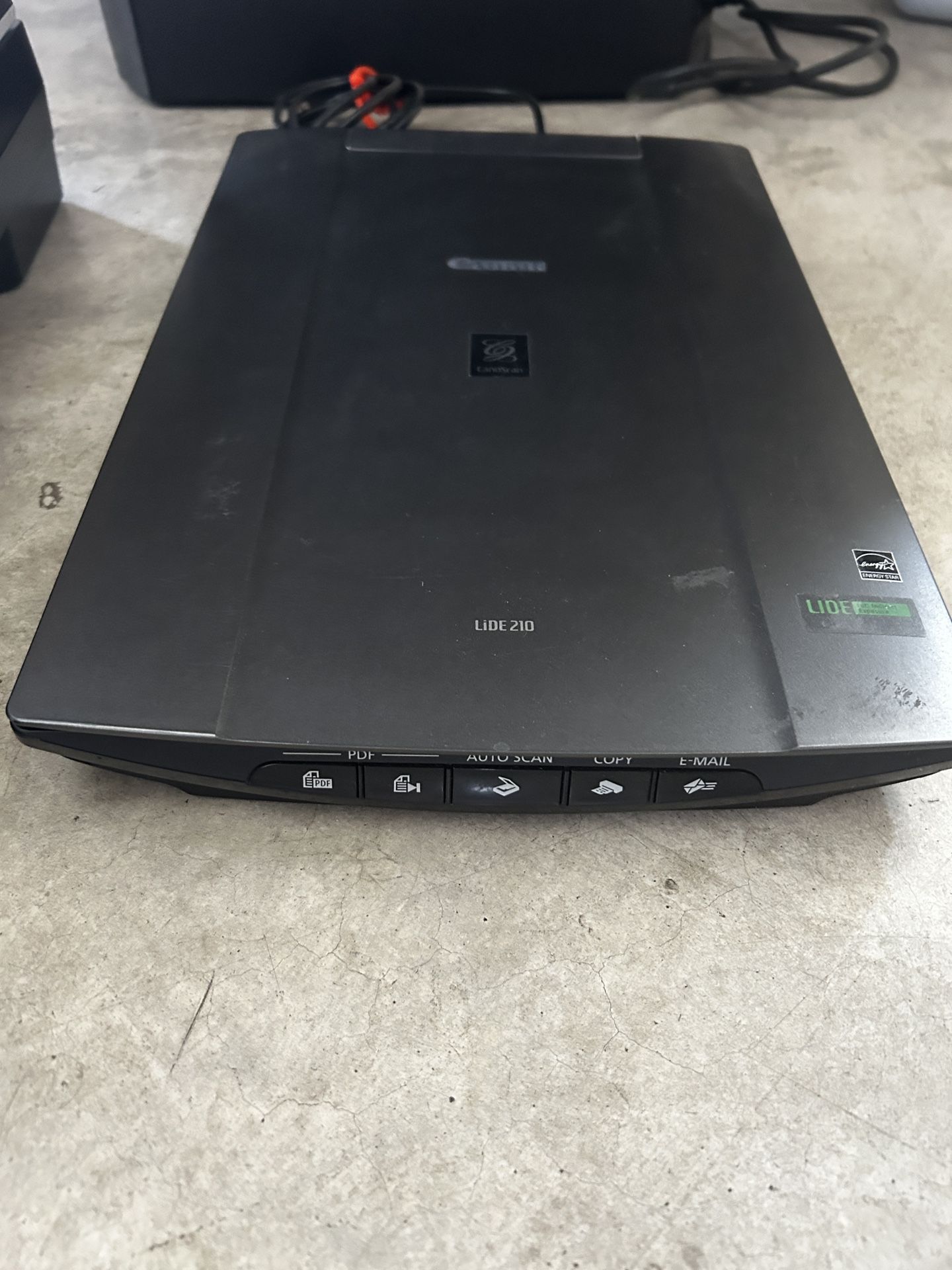 Canon LiDE 210 flatbed scanner with PDF, Auto Scan, Copy, and Email functions.