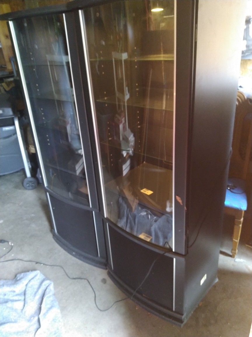 Entertainment Cabinet 64 " In height 22" Wide 18" in Depth.It has lights that Work and three glass shelves. $60 for both!