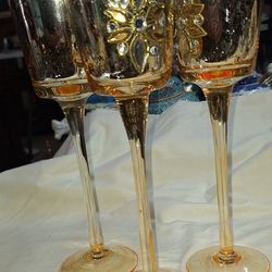Set Of Three Tall Gold Colored Glass Candle Holders 9 1/2 Inches Tall. Some Signs Of Wear A63H005