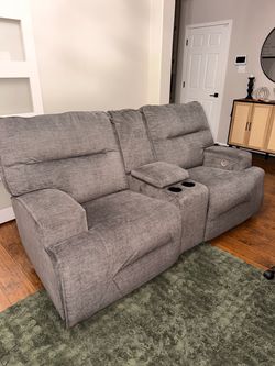 Gray reclining loveseat with charger plug