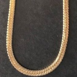 gold-tone herringbone chain necklace with a lobster clasp. 