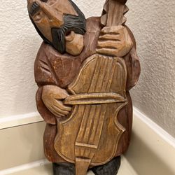 vintage handmade sculpture of a musician carved from wood