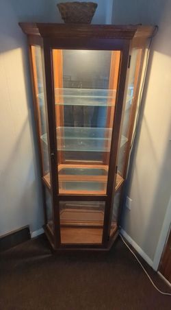 Curio cabinet with glass shelving and wood inlay