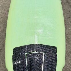 Tim stamps surfboard