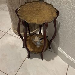 Antique Asian side table wood with 2 ornate brass trays. 20” tall x  about 12.5” round $135 FIRM. 