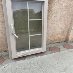 Tan retrofit window opens outwards Measures 23/1/2 High By36 Wide 