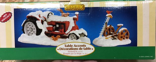 Snow covered tractor and mower table decoration