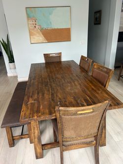 Wooden table with 4 chairs and a bench