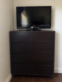 Four drawer dresser in a dark brown wood finish