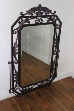 Large, ornate cast iron industrial-grade mirror