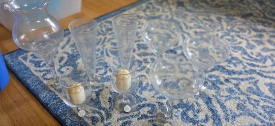 collection of vintage clear glass stemware, specifically Princess House Crystal Heritage items.The set includes champagne flutes, margarita glasses, a