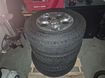 18‑inch OEM Wrangler rim paired with Tamarock A/T LT265/70R18 10‑ply tires.