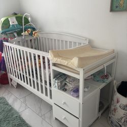 Crib with attached changing table