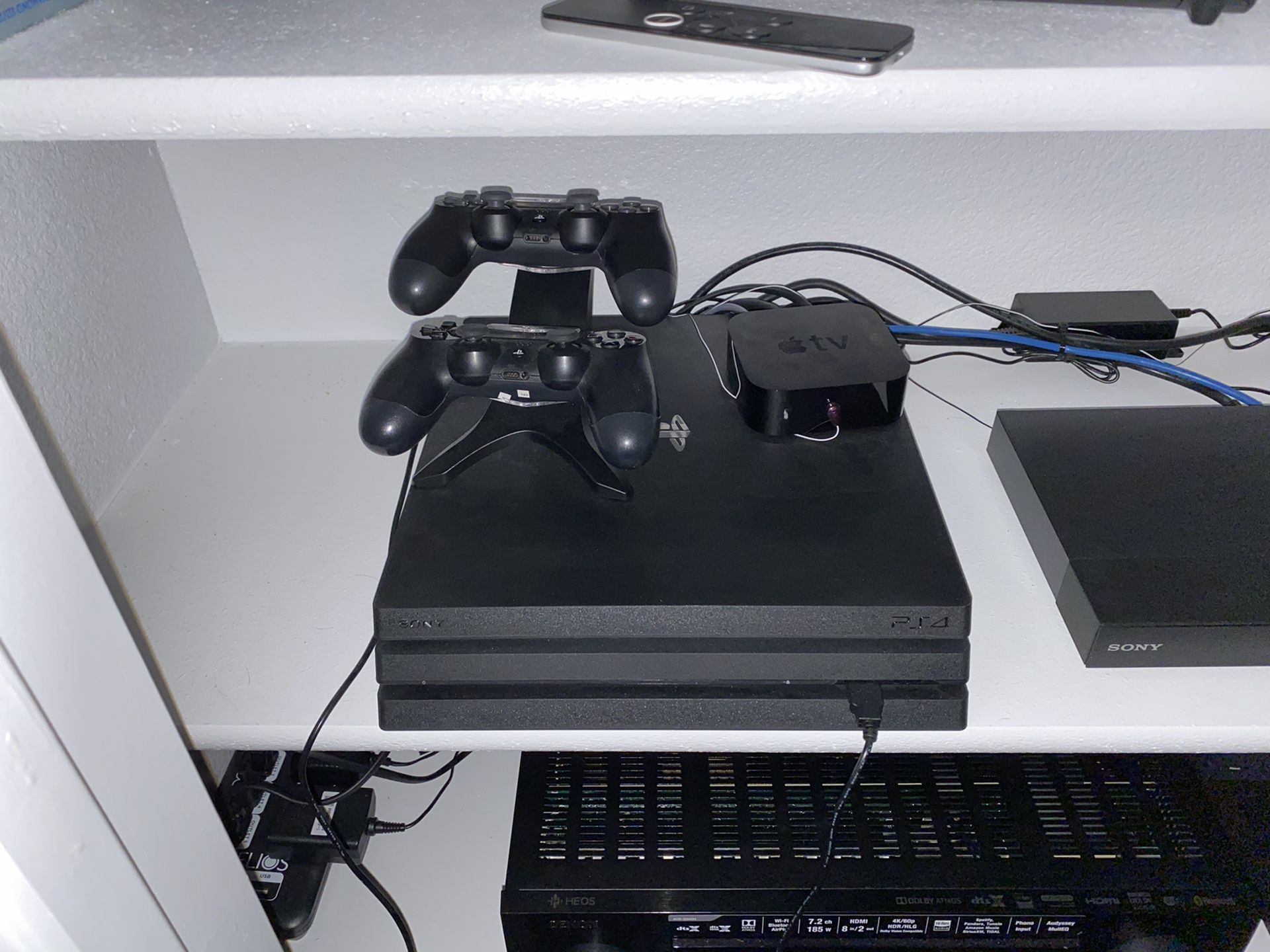 PlayStation 4 pro with 2 controls and charging station