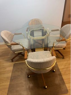 1990s-era Chromcraft dining set features a glass hexagon top and brass swivel chairs