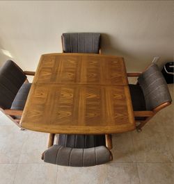 Wood dining table with 4 chairs and leaf.
