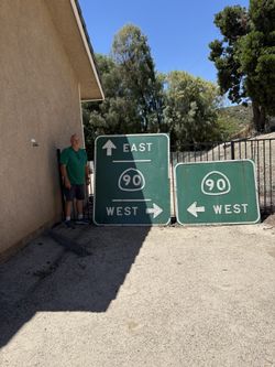 Two large Highway 90 Retired Signs