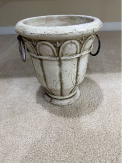 Distressed white garden urn planter with decorative ring handles
