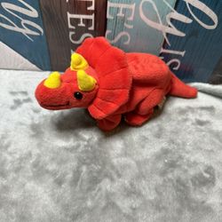 Red plush toy resembling a Triceratops dinosaur
