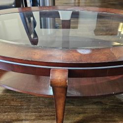 Oval coffee table featuring a glass top