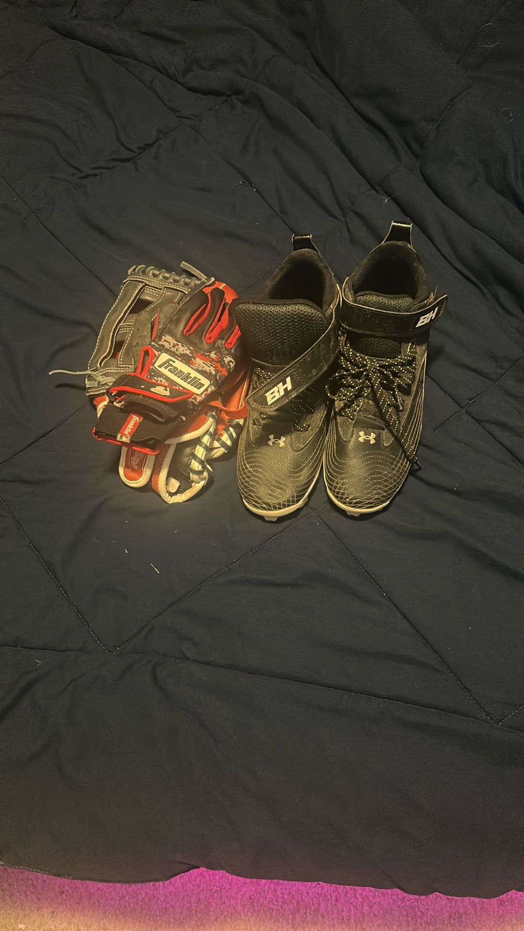 Youth baseball cleats, fielding glove, and batting glove