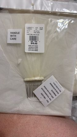 Short Raw edge plain veil with Barrett to clip on top of head.
