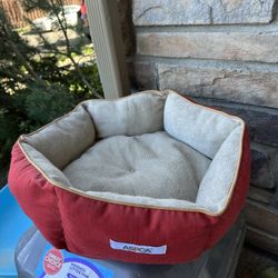 Red circular cat bed - probably medium cat size