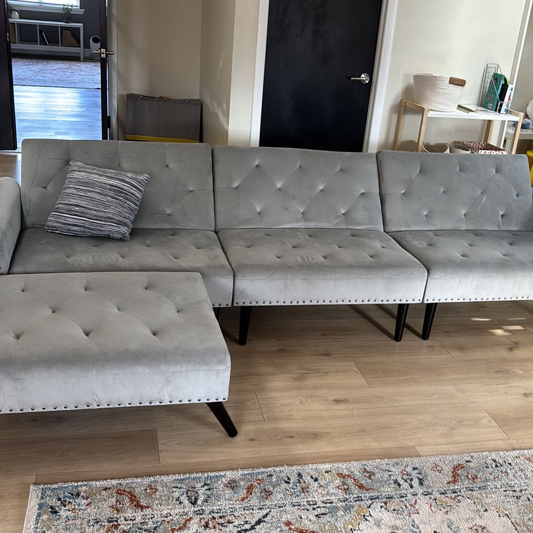 Gray large couch doubles as sleeper
