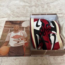Jordan 1 Retro High OG 'Bred' sneakers in red, black, and white with Nike swooshes
