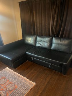 Ikea sleeper sectional couch in the black faux-leather