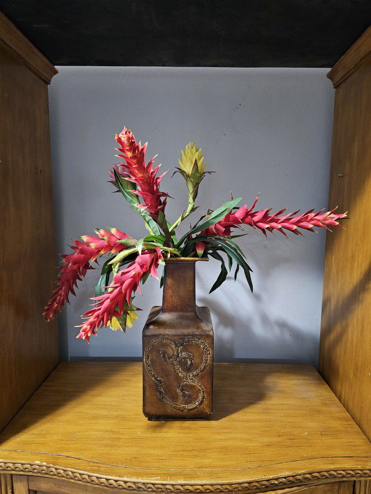 fake flowers in metal vase