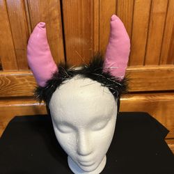 Devil, Pink Horns, And Feathers