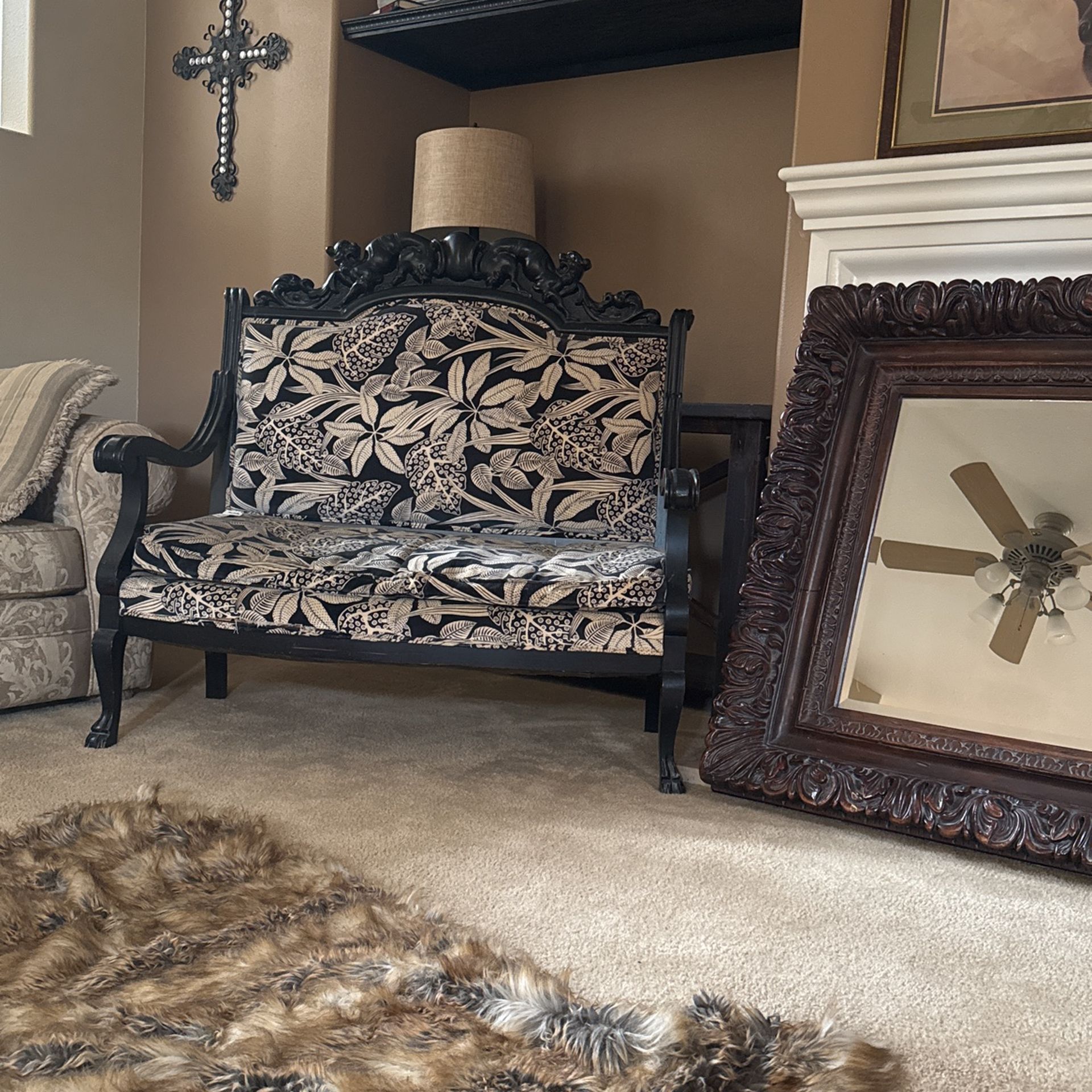 Antique love seat with leopards on the wood