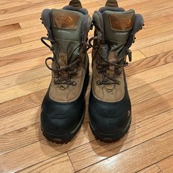 The North Face Baltoro 400 waterproof winter boots with a tan leather upper and black rubber sole.