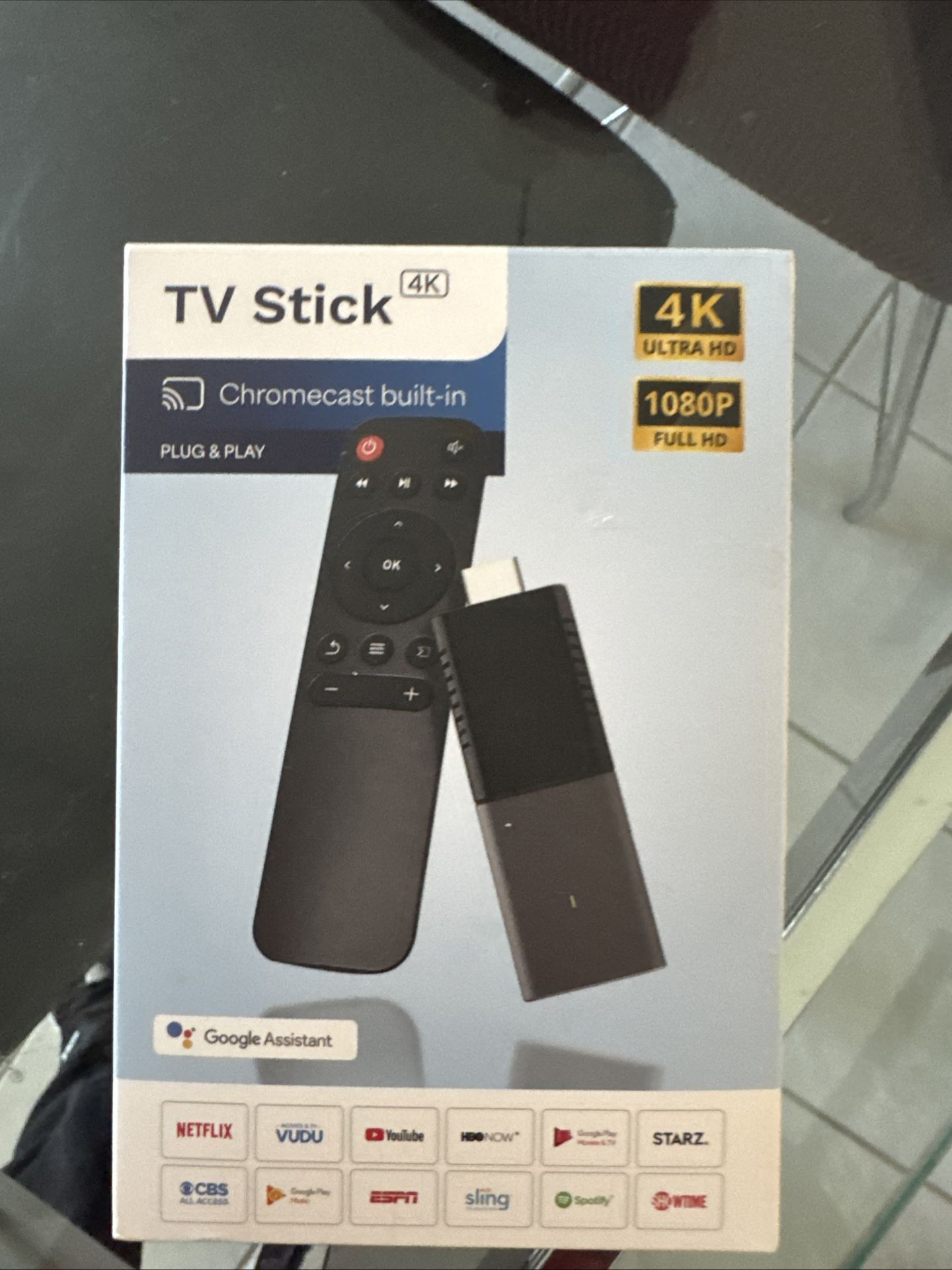 The New In Box 4K Ultra HD TV Stick is a black Android media streamer by Google, featuring a Q