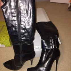 Pair of black leather side-zipped heeled thigh-high boots size 7. normal wear