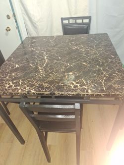 Dinning room table w/ four chairs.