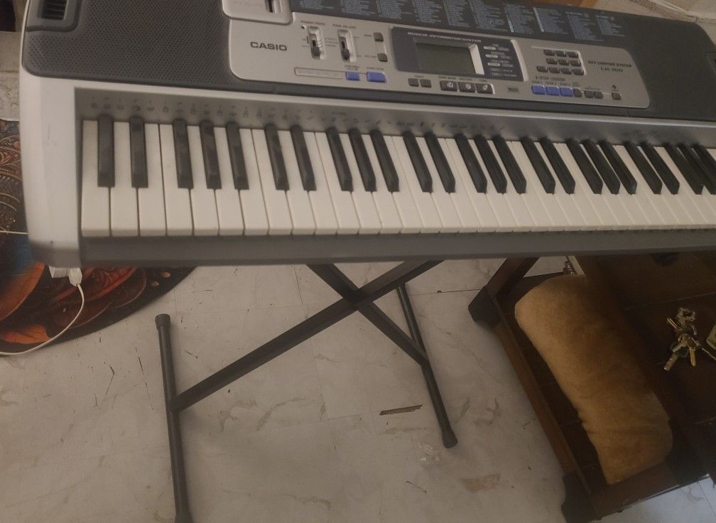 Casio LK-100 61 Silver Lighted Key Electronic Keyboard With Stand