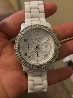 Authentic . Very heavy and pretty Michael Kors watch for a woman .