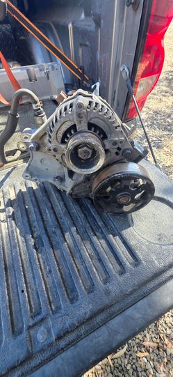 Alternator and pulley housing