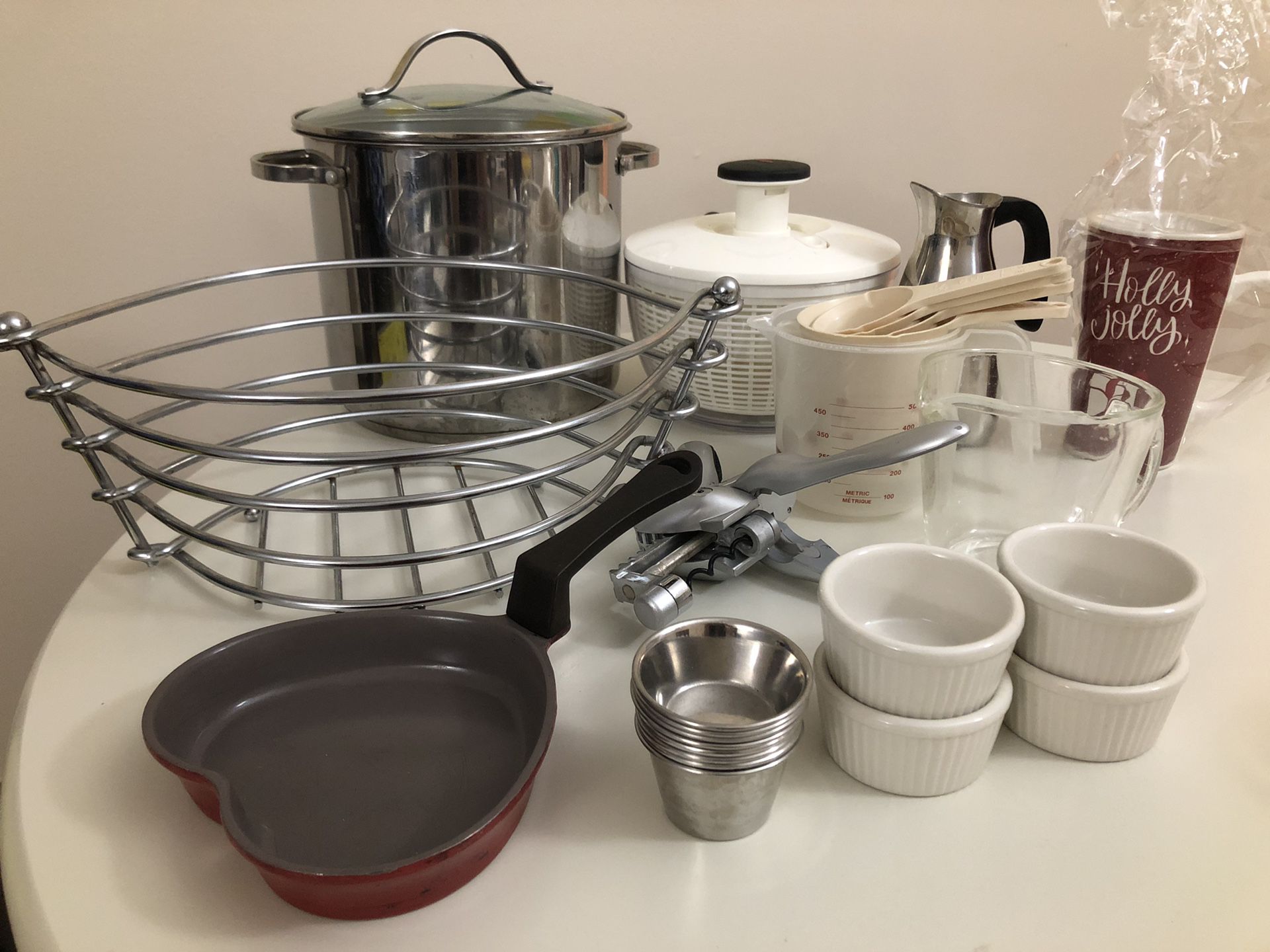 Pots, pans, mugs, salad spinner, measuring cups, bowls, plates, spatula - kitchen tools for cooking