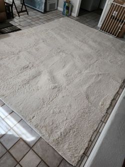 Ophanie 8' x 10' Fluffy cream colored area rug avondale