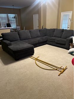 Gray and charcoal colored large sectional sofa